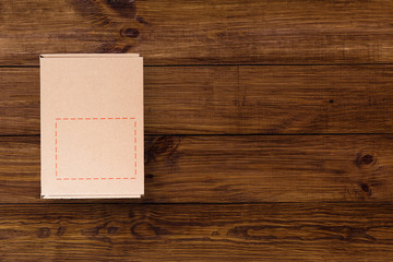 Cardboard box on wooden background