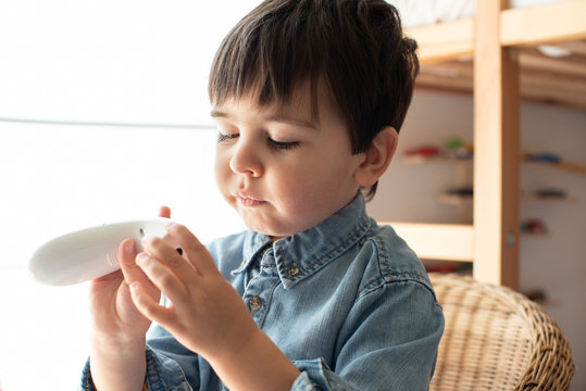 Little boy using a digital thermometer