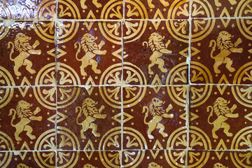 Patterns of an vintage orange golden yellow kitchen tiles with lions and circles