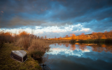 boat on a small lake with reflection in Burgenland