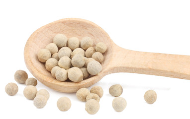 White pepper peas in the wooden spoon isolated on white