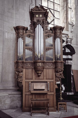 Small Ornamented Wooden Pipe Organ in a church in Grimbergen, Belgium