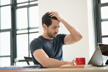 Portrait of freelancer or office man having headaches, stressful of work, depressed or having a fever while working at the office, the concept of pressure from work, working lifestyle, stressful work.