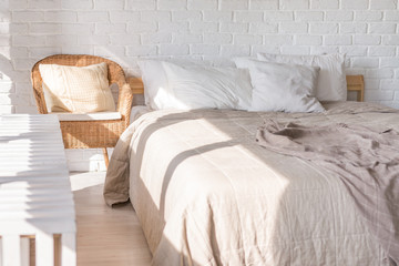 Home interior, bedroom in soft light colors with double bed, bedspread. pillows