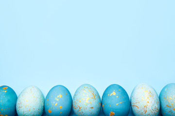 Easter frame of eggs painted in blue color. Flat lay, top view.
