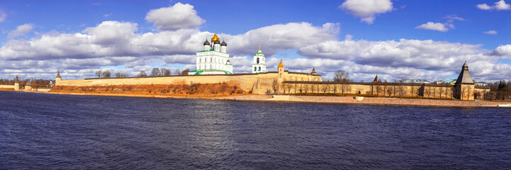 Spring panorama of an old medieval fortress standing on the river Bank. Pskov, Russia.