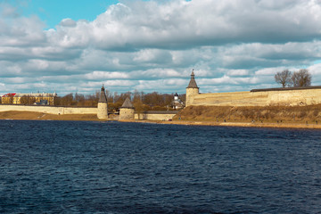 Spring panorama of an old medieval fortress standing on the river Bank. Pskov, Russia.