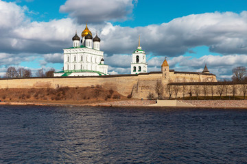 Fototapeta na wymiar Spring panorama of an old medieval fortress standing on the river Bank. Pskov, Russia.