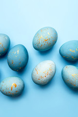 Easter background of eggs painted in blue color. Flat lay, top view.