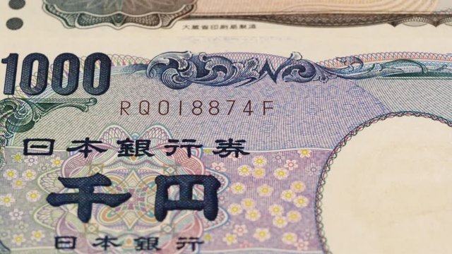 Japan yen notes fast tracking. Japanese currency close up. Slider shot, macro. Low angle, 4K