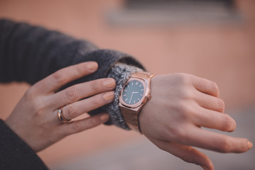 Stylish rose gold watch on woman hand