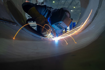 Fototapeta Welding of stainless steel pipes. Semi-automatic arc welding. MIG welding. obraz