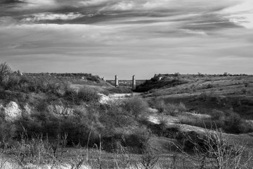 The ruins of an ancient bridge. Landscape. Monochrome.