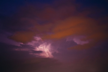 Fototapeta na wymiar City view at night under thunderstorm with strike of lightning. Bad weather. 