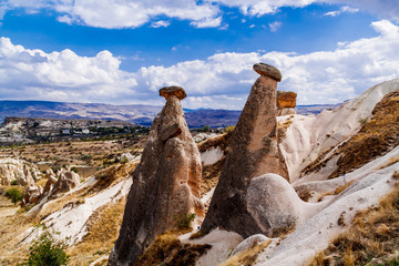 View of famous sandy Twin Fairy Chimneys, in Urgup, Cappadocia area, Turkey