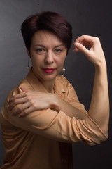 brunette with short hair. Studio portrait in a yellow blouse