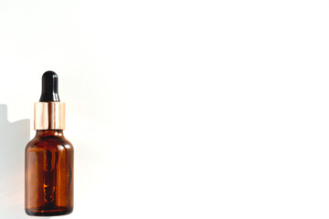 brown bottle with pipette on a white background. the view from the top