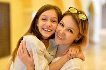 Portrait of happy mother with daughter hugging