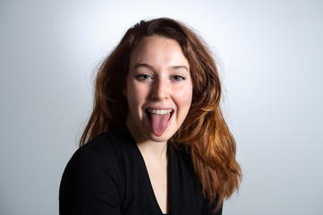Portrait of cheerful charming young brunette woman looking at camera over white background. Girl...