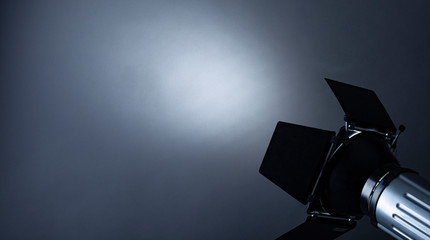 Spotlight shining on grey background