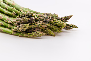 Close view of fresh green asparagus isolated on white background