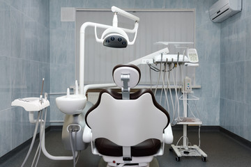 Dentist office. Modern dental cabinet. Dental instruments and tools in modern clinic, professional dentistry chair waiting to be used by orthodontist