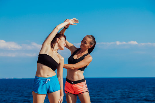 trainer helps the girl to do the exercises