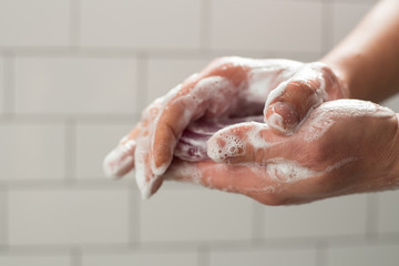 Fototapeta premium A man washing hands with soap. Preventing spreading virus concept.