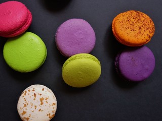 layout of colored macaroons on a solid color background