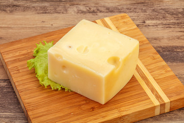 Emmental cheese over wooden board