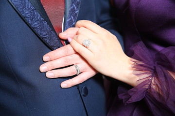 Celebrated youngsters have tickets in their hands. The bride took the bride's hand . Woman took the mans hand.
