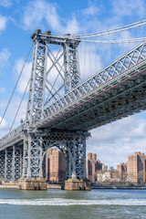 Obraz premium Williamsburg Bridge shot from the water on a ferry with manhattan wall street behind new york city nyc USA