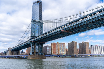 Fototapeta premium Manhattan Bridge shot from the water on a ferry with manhattan wall street behind new york city nyc USA