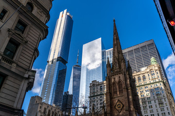 Fototapeta na wymiar the top of trinity church in front of skyscrapers, new york city