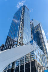 Reflections of the clouds on a glass skyscraper in new york city, scenic view from below