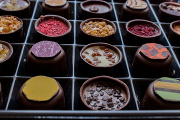 Various of sweet confectionery with chocolate candies and pralines. Handmade box of chocolates. Realistic chocolate set, delicious dessert pattern.