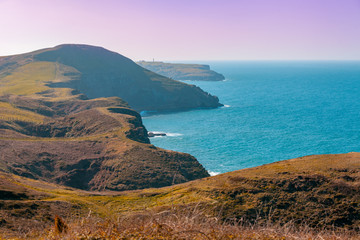 Seascape in early spring. Rocky steep seashore. Sea nature landscape. View of the sea from mountain.