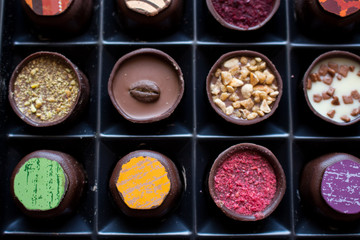 Various of sweet confectionery with chocolate candies and pralines. Handmade box of chocolates. Realistic chocolate set, delicious dessert pattern.