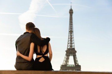 Couple looking at Eiffel tower, romantic date in Paris. Honeymoon, travel to France