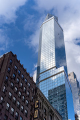 Reflections of the clouds on a glass skyscraper in new york city, scenic view from below