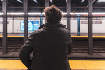 Commuter in the New york Subway waiting for the metro train