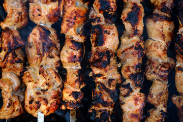 Preparation of shish kebab on outdoor charcoal grill