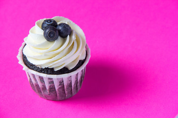 Homemade chocolate muffin on a pink background. Homemade baking.