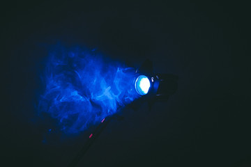  spotlight on a black background with smoke, blue glow