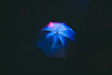 umbrella on black background , blue and red smoke