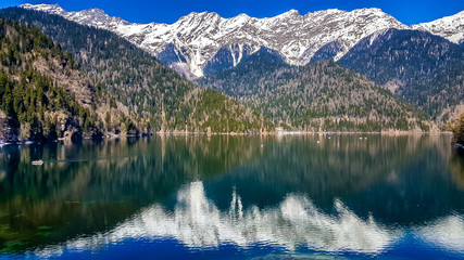 Lake Ritsa in the Caucasus Mountains, in the north-western part of Abkhazia, surrounded by mixed mountain forests and subalpine meadows.