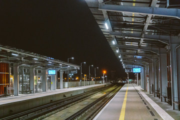 Train station at Gdansk airport GDN in Poland. railway platform of Lech Walesa Airport in Gdansk, Poland. Gdansk Airport lotnisko train station. Platform of Pomeranian Metropolitan Railway at night