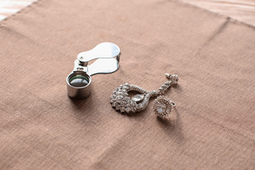 Jewelry and magnifier on table in workshop