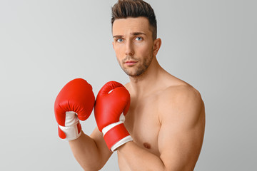 Handsome young boxer on grey background