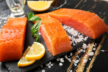 Raw salmon fillet on table